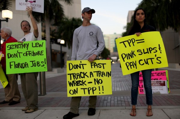 Union members and community activists rally to protest the TPP in Miami, FL.